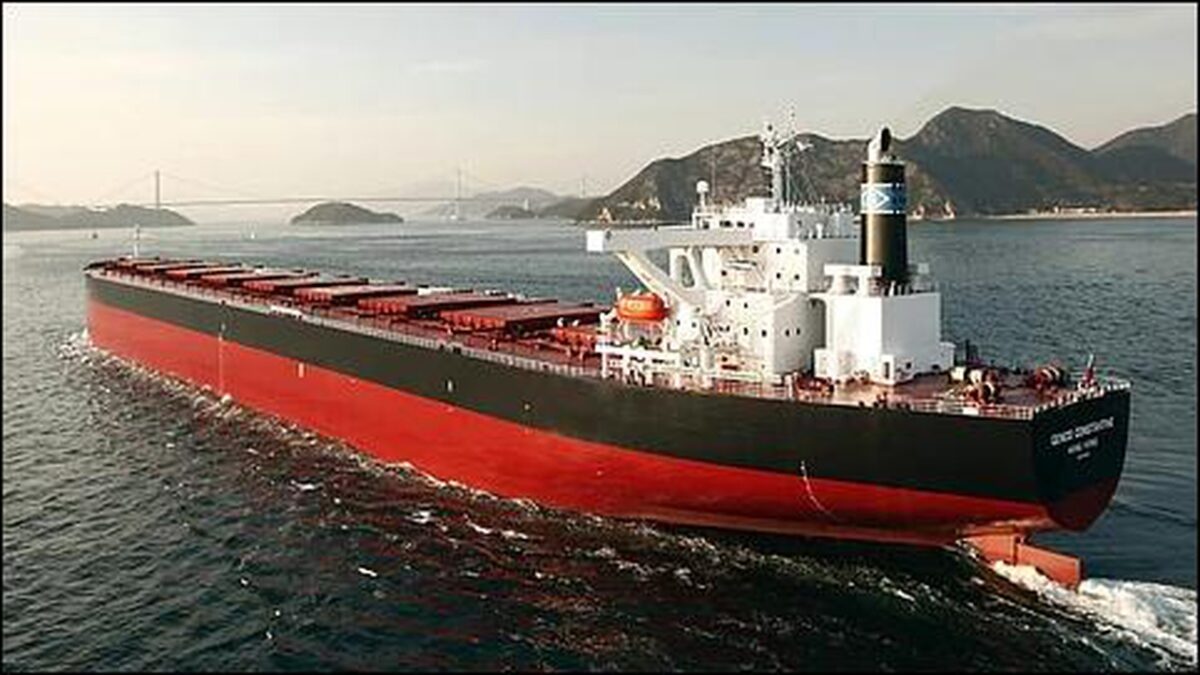 A large Genco dry bulk carrier vessel navigates open seas.
