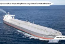 A massive crude oil tanker under construction in a bustling shipyard.