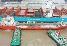 Maersk container ship undergoing ship-to-ship methanol bunkering from a tanker.