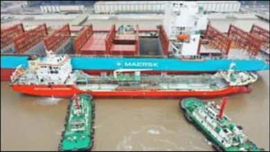 Maersk container ship undergoing ship-to-ship methanol bunkering from a tanker.