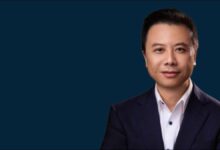 Gordon Li, Flexport's Head of Greater China, in a professional portrait over a busy port background.