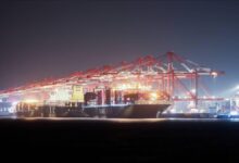 Colorful shipping containers stacked at a bustling port, representing global trade and logistics.