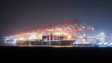 Colorful shipping containers stacked at a bustling port, representing global trade and logistics.
