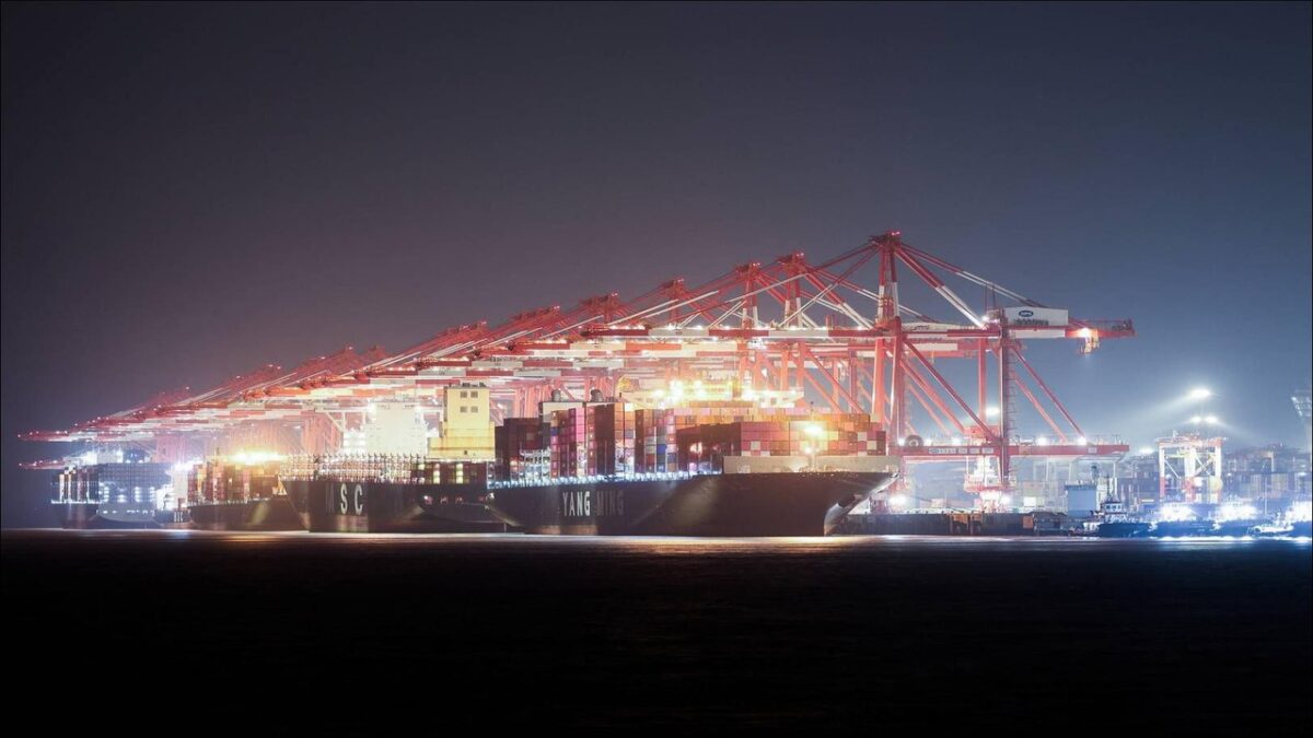 Colorful shipping containers stacked at a bustling port, representing global trade and logistics.