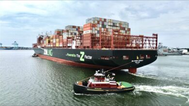 Tugboat assists a large ZIM LNG-fueled container ship in a Virginia port.