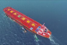 A massive Very Large Ore Carrier (VLOC) sailing on blue waters.