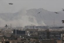 Smoke and debris rise from an explosion amidst the Iran-Middle East conflict.