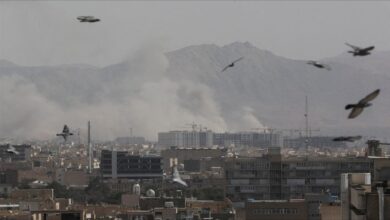Smoke and debris rise from an explosion amidst the Iran-Middle East conflict.