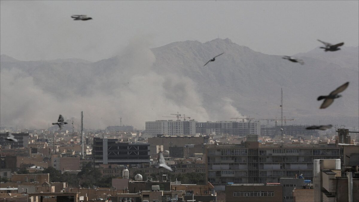 Smoke and debris rise from an explosion amidst the Iran-Middle East conflict.