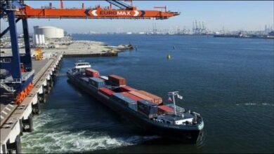 A large vessel receiving marine fuel from a bunker barge in the busy port of Rotterdam.