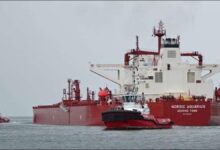 A large oil tanker vessel on the water, representing a firm's exit from the Strait of Hormuz.