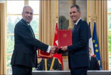 Asyad and CMA CGM executives shake hands, symbolizing their strategic partnership agreement.