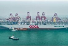 OOCL Wisdom dual-fuel container ship with a bunkering vessel alongside.