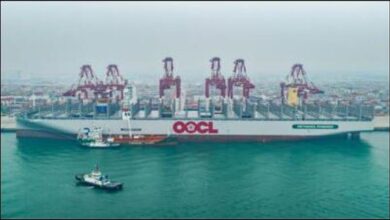 OOCL Wisdom dual-fuel container ship with a bunkering vessel alongside.