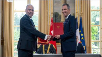 Asyad and CMA CGM executives shake hands, symbolizing their strategic partnership agreement.