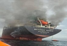 A large commercial ship navigates a shipping lane, reflecting global concerns in the Strait of Hormuz.