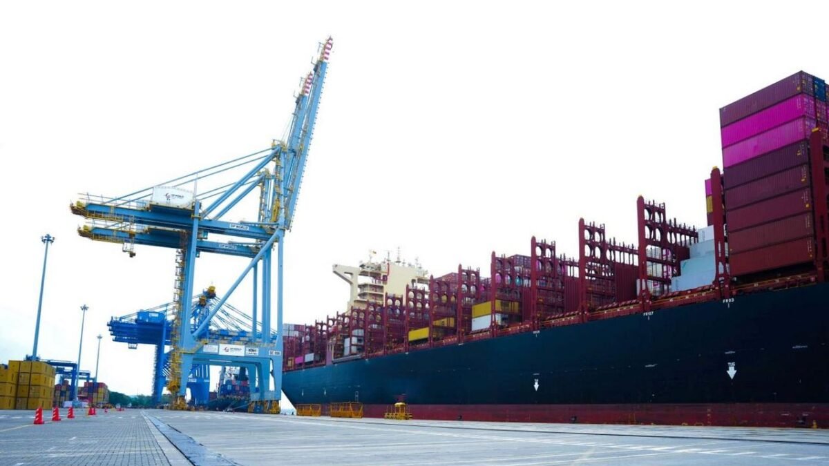 A large container ship sails across the ocean, symbolizing global freight and shipping rates.