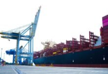 Massive container ship loaded with cargo containers at sea for global shipping.