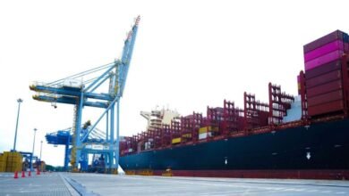 Massive container ship loaded with cargo containers at sea for global shipping.