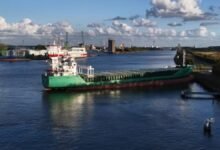 Irish cargo ship Arklow Falcon aground against a Dutch canal embankment.