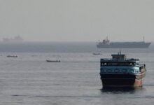 Large container ship sails a shipping lane, symbolizing Suez Canal and Red Sea routes.