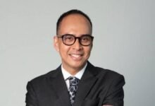 A modern logistics warehouse with stacked goods and forklifts, reflecting AC Logistics' market goals.