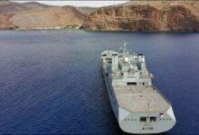Royal Fleet Auxiliary tanker RFA Tidespring sails on blue water.