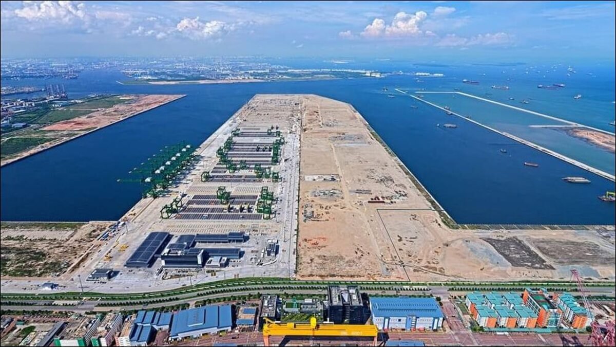 Modern Tuas Port in Singapore bustling with container ships and cranes, representing Asian maritime trade.