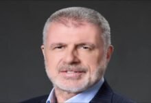 Wallem Group CEO John Rowley looks forward in a professional office setting.