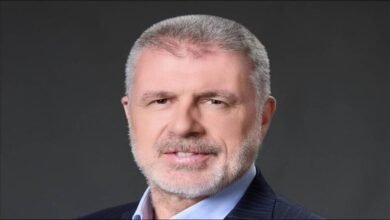 Wallem Group CEO John Rowley looks forward in a professional office setting.