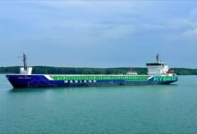 Wind-assisted combi freighter sailing on the open sea.