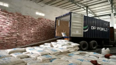 A large cargo ship unloads vital WFP rice aid at an East African port.