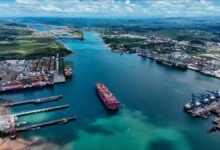 A large bulk carrier ship transports cargo through a global trade route.