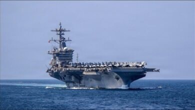 The USS Abraham Lincoln aircraft carrier at sea with planes on its flight deck.