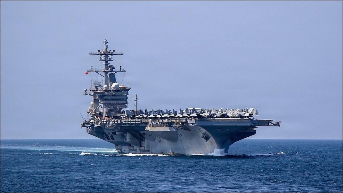 The USS Abraham Lincoln aircraft carrier at sea with planes on its flight deck.