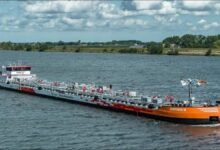 Multiple barges navigate the Rhine River, representing HGK's drought-resilient fleet plan.