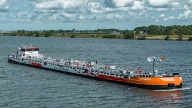 Multiple barges navigate the Rhine River, representing HGK's drought-resilient fleet plan.