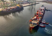 Large cargo ship at sea with a bunkering vessel, illustrating marine fuel transfer operations.