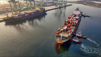 Large cargo ship at sea with a bunkering vessel, illustrating marine fuel transfer operations.