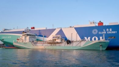 A large vessel being bunkered at a busy port, representative of marine fuel supply chains.