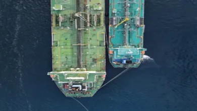 A large cargo vessel sails across the open ocean, representing marine fuel consumption.