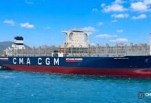 A large CMA CGM methanol-powered container ship on the water.