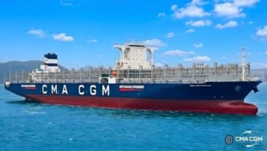 A large CMA CGM methanol-powered container ship on the water.