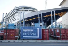 A cruise ship under construction inside a large German shipyard.