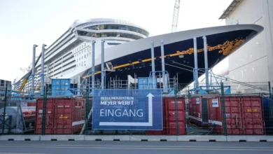 A cruise ship under construction inside a large German shipyard.