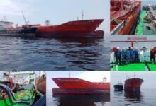 Malaysian maritime enforcement personnel alongside a detained vessel at sea.