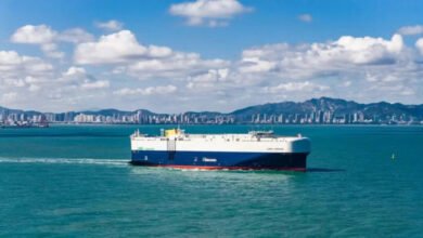 A modern LNG dual-fuel car carrier (PCTC) sails, symbolizing Global Car Carriers' growth.