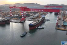 China's Hengli Shipyard with large vessels under construction and numerous cranes.