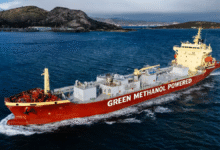 A large methanol-powered cement carrier ship sails on the water.