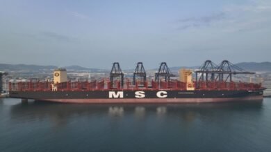 A large, modern Pure Car and Truck Carrier (PCTC) ship at sea.